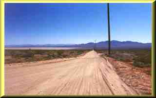 Power Line Road looking South with dry lake in back ground.